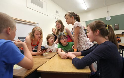 Grade six Windsor School students lean in to look at the award Sydney (right) won (Marion & Dean Finlay Citizenship Award) on their last day of school Thursday.  Story by Carolin Vesley, 2017 feature. June 29, 2011 (RUTH BONNEVILLE / WINNIPEG FREE PRESS)