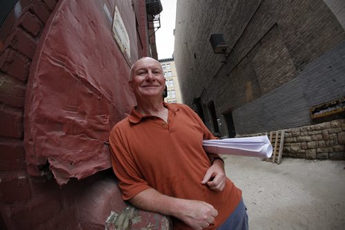 Richard Walls of ADI Design Group looks over plans for a development project he is planning for the Exchange District in Winnipeg Thursday, June 30, 2011. Walls is planning to build three 700 square foot apartments above a laneway connecting two buildings. It's part of the Pan Am Place development, which is an innercity housing and mentoring facility for at risk youth. (John Woods/Winnipeg Free Press)