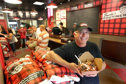 Jeff Baron, owner of Smoke's Poutinerie on Albert Street holds a large Canadiana poutine specialty inside his store in Old Market Square.   For Xtra, Dave Conners.  July 2 2011 (RUTH BONNEVILLE / WINNIPEG FREE PRESS) NOTE: Jeff Baron is not part of the business anymore