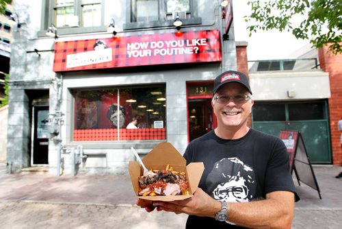 Jeff Baron, owner of Smoke's Poutinerie on Albert Street holds a large Canadiana poutine specialty outside his store in Old Market Square.   For Xtra, Dave Conners.  July 2 2011 (RUTH BONNEVILLE / WINNIPEG FREE PRESS) NOTE: Jeff Baron is not part of the business anymore