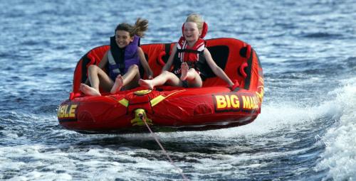 BORIS.MINKEVICH@FREEPRESS.MB.CA   BORIS MINKEVICH / WINNIPEG FREE PRESS 110702 Long Weekend fun on Longbow Lake, just east of Kenora, Ontario. A pair of 9 year olds, Abby Dent and Nori Sigvaldason catch some air while tubing behind Nori's family's new boat on the lake.
