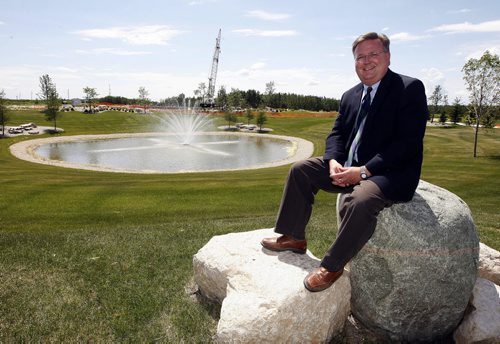 Michael Falk  Development Mgr for Terracon Developments  Ltd. they have poured a foundation ( in background with crane )for  45,000 sq ft office warehouse  - story by Murray McNeill ( KEN GIGLIOTTI  / WINNIPEG FREE PRESS ) July 6 2011