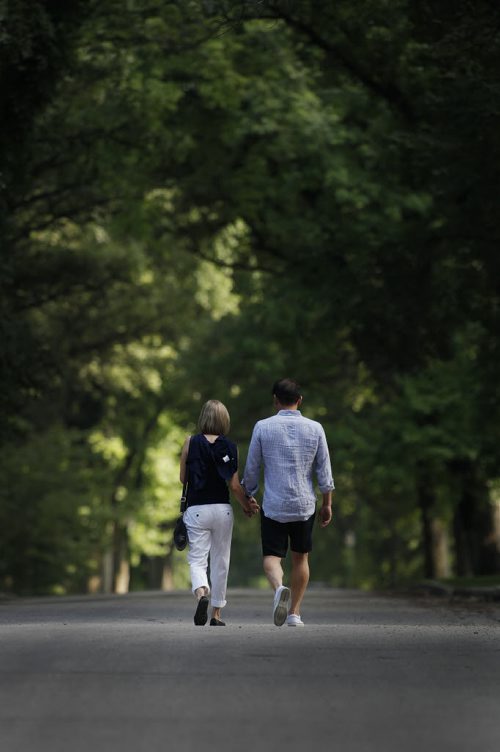 Phil and Lori Poon walk along their River Heights street in south Winnipeg Thursday, July 7, 2011. (John Woods/Winnipeg Free Press)