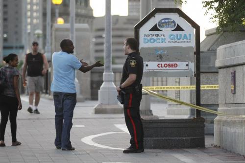 Police guard a scene at the south east side of the Norwood Bridge on Main Street after a person was found unconscious and in critical condition after an assault in Winnipeg, Saturday, July 9, 2011.   John Woods/Winnipeg Free Press