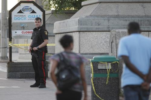 Police guard a scene at the south east side of the Norwood Bridge on Main Street after a person was found unconscious and in critical condition after an assault in Winnipeg, Saturday, July 9, 2011.   John Woods/Winnipeg Free Press