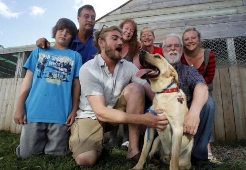 Geordie Ross with Miles the dog is surrounded by (L-R) Dayton Cosford and his dad Dave, Rhonda Cook, Tracy "Hannah" Baldwin, Greg Mitchell, and Sharai Ross. Sharai's sister sent their 13 month old lab down and Geordie lost it, but with the team of good samaritans got the dog back. July 11, 2011 (BORIS MINKEVICH / WINNIPEG FREE PRESS)