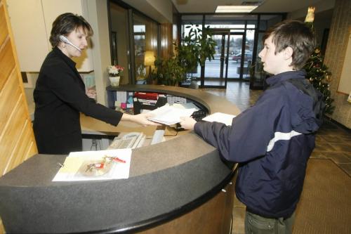 John Woods / Winnipeg Free Press / November 24, 2006 - 061124  - Zach Blady-Bludau, grade 9 Silver Heights student, hands a petition to St James-Assiniboia School Division staff member  at their Portage Avenue office Friday, Nov 24/06.   The petition asks the school division to include the words Silver Heights in the name of a new school that will be built to combine Sturgeon Creek and Silver Heights.