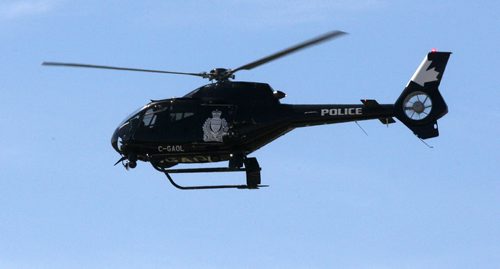 Winnipeg Police helicopter flies over fire scene on Nairne Ave to refuel nearby  July 13,  2011   (JOE BRYKSA / WINNIPEG FREE PRESS)