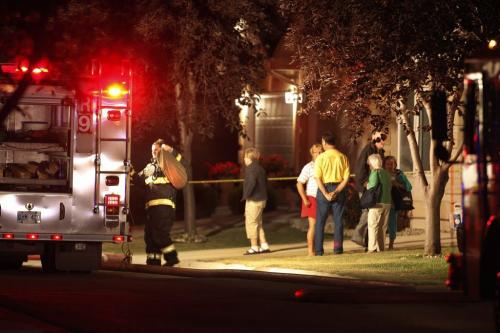People gather outside a home in Normand Park Cove at 2270 St. Mary's Road early Friday morning after a fire engulfed the residence in the gated complex in Winnipeg, Friday, July 15, 2011.  According to a fire official two people were conveyed to hospital. John Woods/Winnipeg Free Press