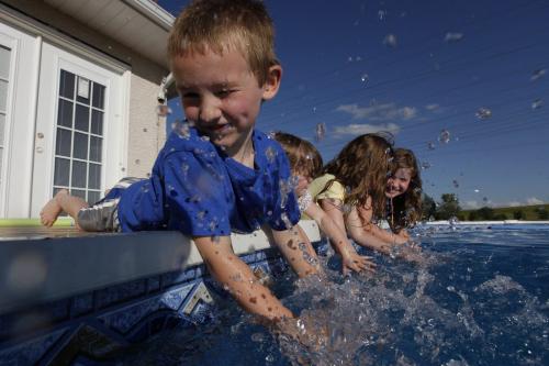 Matthew (6), Kaitlyn (3), Abby (6) and Emma (8) Sywake have fun in the grandpas new pool in Winnipeg, Friday, July 15, 2011.  John Woods/Winnipeg Free Press