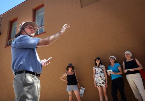 Brandon Sun David McConkey leads a tour of heritage buildings and the stories behind them, Saturday afternoon in the downtown. The tour was part of the annual "Doors Open Brandon" event, which helps show and educate the public about the city's history. (Colin Corneau/Brandon Sun)