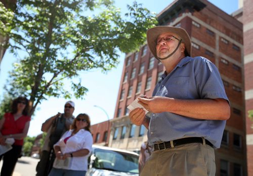 Brandon Sun David McConkey leads a tour of heritage buildings and the stories behind them, Saturday afternoon in the downtown. The tour was part of the annual "Doors Open Brandon" event, which helps show and educate the public about the city's history. (Colin Corneau/Brandon Sun)