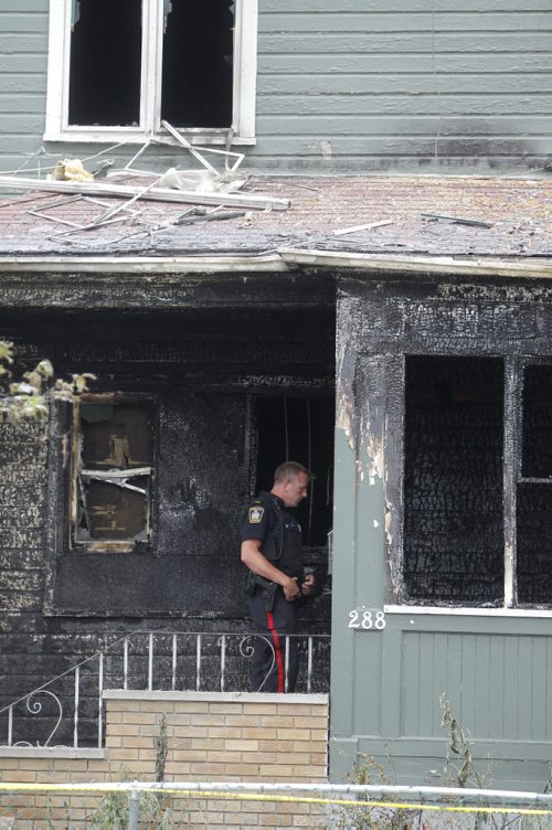 Police at the scene of a house fire on Austin Street North that claimed the lives of four people early this morning. July 16, 2011. (TREVOR HAGAN/WINNIPEG FREE PRESS) - See Bill Redekop story