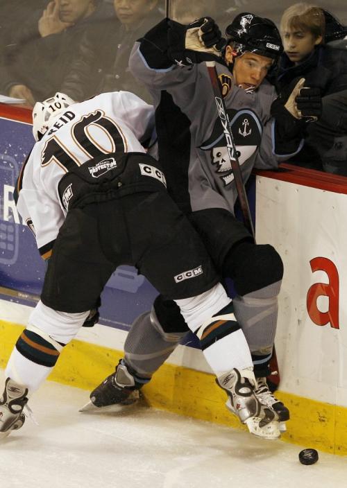 John Woods / Winnipeg Free Press / November 25, 2006 - 061125  - Moose Brandon Reid (10) takes out Admirals Bracken Kearns (46) in first period AHL action in Winnipeg Saturday Nov 25/06.