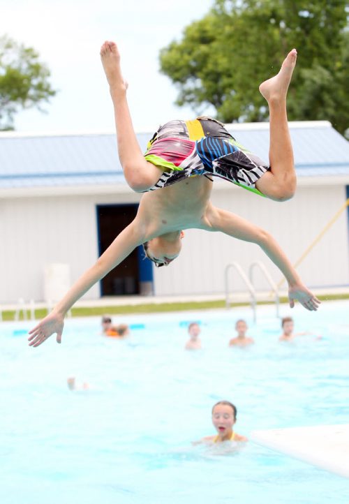 Brandon Sun 18072011 Brian Harris dives off of the diving board on the opening day of the Wawanesa and District Water Park in Wawanesa, Man. on a scorching hot Monday afternoon. (Tim Smith/Brandon Sun)