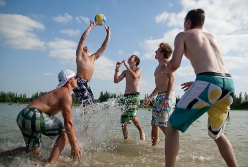 From left, Riley Derlago, Tanner Pescitelli, Cory Stefanyshyn, Soren Frederiksen, and Tyler Edwards play volleyball at Birds Hill Park beach on a record-breaking hot day, Tuesday.  July 19, 2011 (HADAS PARUSH / WINNIPEG FREE PRESS)