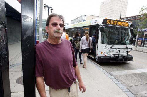 Retired bus driver Pat Ahoff poses for a photo at a downtown bus stop. July 20, 2011 (BORIS MINKEVICH / WINNIPEG FREE PRESS)
