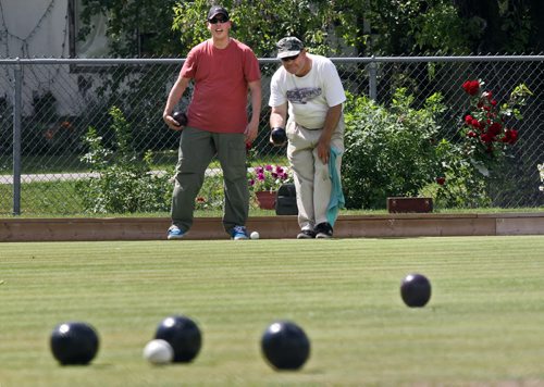 Brandon Sun Tim Lanes bowls with John (declined to give his last name) on a sunny Wednesday afternoon at the Wheat City Lawn Bowling Club in Rideau Park. Lanes cares for the grounds and has been going to the club for 39 years, and interested John in an introductory game as he wandered past. (Colin Corneau/Brandon Sun)