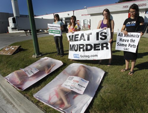 PETA members held a pro-vegan demonstration in front of Dunn-Rite Food Products Ltd. on Hamelin St. Thursday morning. The activists' aim is to demonstrate that all animalsincluding humansare made of flesh, blood, and bone; that animals have the same five senses and range of emotions as humans do. A group of PETA members are travelling from Thunder Bay to Victoria B.C holding demonstrations at slaughterhouses, steak houses and butcher shops along the way. See release.   (WAYNE GLOWACKI/WINNIPEG FREE PRESS) Winnipeg Free Press July 21 2011