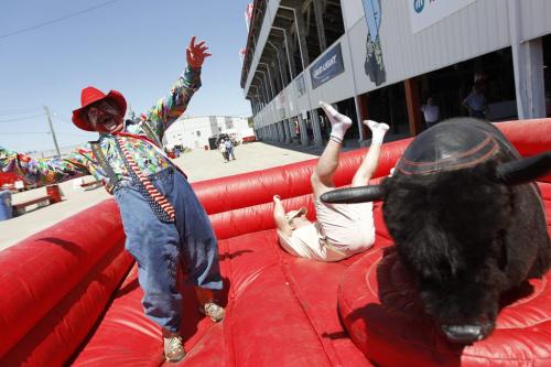 Doug Speirs of the Winnipeg Free Press is bucked from "Tequila" the Mechanical Bull at the Manitoba Stampede in Morris on July 21st, 2011. Rodeo Clown, Bert Davis looks on. (TREVOR HAGAN/WINNIPEG FREE PRESS)