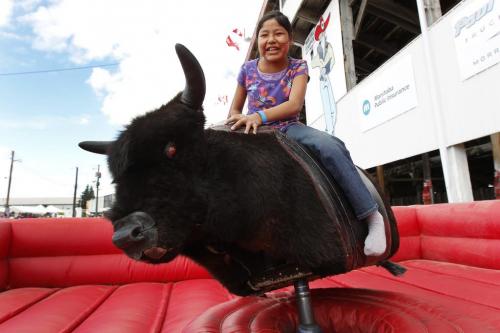 Charity Woods (11) enjoys a ride on an electric bull at the Morris Stampede in Morris, Friday, July 22, 2011.  John Woods/Winnipeg Free Press