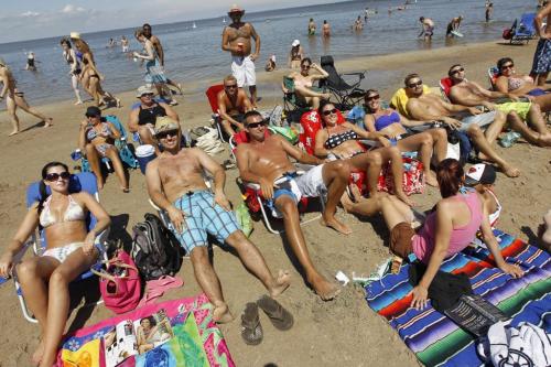 Self proclaimed "Grand Beach Locals" enjoying a sunny afternoon at the beach. From left, Crystal, Mike, Mike, Darcie, Tracey, Brian, Arron and Carly. (TREVOR HAGAN/WINNIPEG FREE PRESS)
