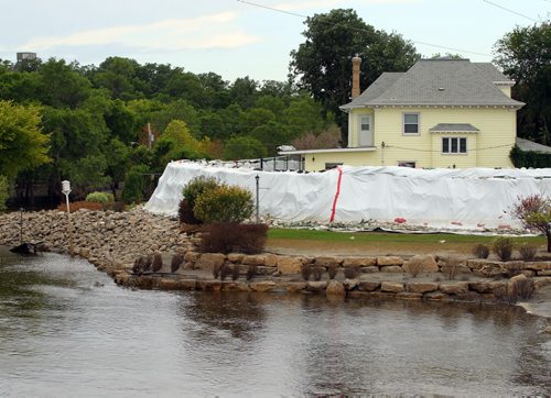 Brandon Sun A home on the Souris River lies behind a wall of sandbags even as waters recede, Tuesday afternoon. Like Brandon before it, Souris has plenty of evidence of a fierce flood flight remaining after the river crested on July 6. (Colin Corneau/Brandon Sun)
