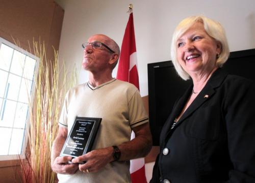 Arvid Loewen (left) receives an "International Hero Award" from Joy Smith, MP for Kildonan-St. Paul at her office. Arvid Loewen crossed Canada by bicycle to raise money for children in Kenya. 
July 27, 2011. 
Mike Deal / Winnipeg Free Press