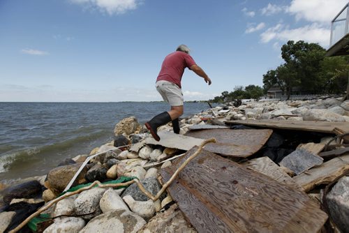 Don Easton, a home owner at Twin Lakes Beaches surveys garbage and debris that has collected along the shores of Lake Manitoba. Photo's of Twin Lakes Beaches. Saturday Special, Follow-up on Manitoba 2011 Flood by Melissa Martin. July 27, 2011 (RUTH BONNEVILLE / WINNIPEG FREE PRESS)
