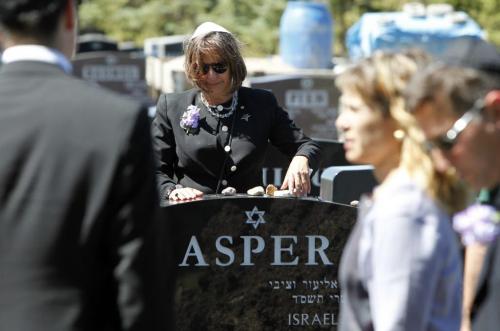 Gail Asper handles soome stones on the Asper headstone at the cemetery. Her mother Ruth Miriam Asper was commonly known as Babs to her family, friends and the community, and died early Saturday at the age of 78 at St. Boniface General Hospital. August 2, 2011 (BORIS MINKEVICH / WINNIPEG FREE PRESS)