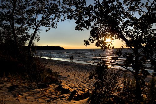 A family strolls along the shores of Grand Beach as the sun sets after another beautiful day on the August long weekend   2011 (RUTH BONNEVILLE / WINNIPEG FREE PRESS)