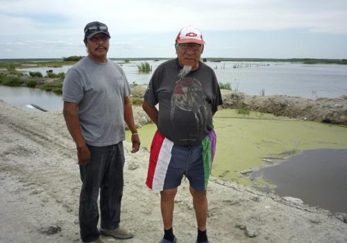 For Story on state of affairs at flooded-out First Nation,  Lake St. Martin, three months after population of 725 evacuated to Winnipeg. Frank Beardy and son Clint Beardy stand on unfinished ring dike in the Beardy backyard, Lake St. Martin First Nation. 110803 - Wednesday, August 03, 2011 -  ALEXANDRA PAUL / WINNIPEG FREE PRESS