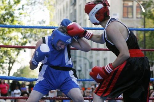 Dylan Muirhead (Blue) and Jordan Daman (Black) box in the first annual Take It Outside boxing event on Arthur Street in downtown Winnipeg Saturday, August 6, 2011.  The event is a fund raiser for disadvantaged youth at Pan Am Place. John Woods/Winnipeg Free Press