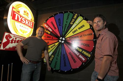 Luxalune's Chris And Lawrence Warwaruk pose for a photo in their night club where there is a birthday prise spinning wheel. August 9, 2011 (BORIS MINKEVICH / WINNIPEG FREE PRESS)