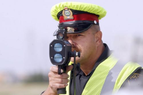 Wpg Police have found that 34% of drivers  were over the speed limit  in a two day period on Bishop Grandin , this findings have prompted a crack down - in pic Sgt Lou Malo uses speed traffic laser to monitor  speed  in the area -  Jen Skerritt Story - Police traffic Laser Enforcement for Saturady ( KEN GIGLIOTTI  / WINNIPEG FREE PRESS ) Aug 12 2011 -
