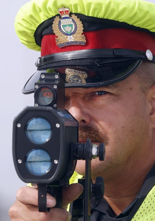 Wpg Police have found that 34% of drivers  were over the speed limit  in a two day period on Bishop Grandin , this findings have prompted a crack down - in pic Sgt Lou Malo uses speed traffic laser to monitor  speed  in the area -  Jen Skerritt Story - Police traffic Laser Enforcement for Saturady ( KEN GIGLIOTTI  / WINNIPEG FREE PRESS ) Aug 12 2011 -