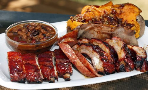Bernies  BBQ Ribs , Sweet potatos and Burbon Maple Beans  Bernie Lutz of Smokin Hawg BBQ  , last years winner  of the rib portion of the Manitoba Open  Barbecue  Competition , ( KEN GIGLIOTTI  / WINNIPEG FREE PRESS ) Aug 18 2011