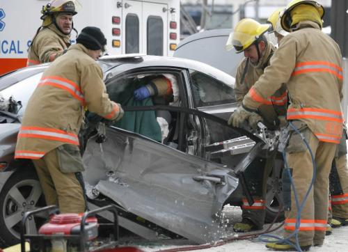 John Woods / Winnipeg Free Press / December 3, 2006 - 061203  - Emergency personnel work to extricate the driver of a car that was t-boned by a crane at the intersection of York and Edmonton at about 12:30 Sunday Dec 3/06.