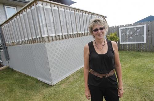 Brenda Goran runs a unique business called Design Equations that makes mesh tarps for houses .  August 11, 2011 (BORIS MINKEVICH / WINNIPEG FREE PRESS)