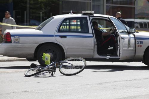 Police investigate at the scene of an serious motor vehicle collision involving a cyclist at the intersection of Mountain Avenue and McGregor Street in Winnipeg Friday, August 19, 2011. The cyclist was transported to hospital in critical condition. John Woods/Winnipeg Free Press