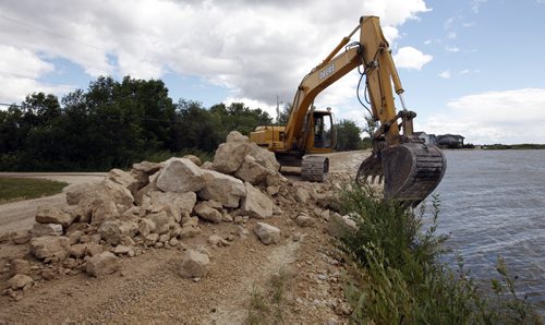 Water Conditions on Lake Winnipeg has Gimli and area preparing for  high water levels - the road  into Willow Island just south of Gimli is being raised dumping rock to  reenforce and arise the existing road  ( KEN GIGLIOTTI  / WINNIPEG FREE PRESS ) Aug 19 2011