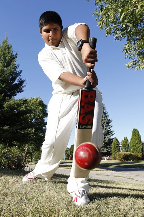 Fourteen year old cricket player Sarbjot Singh practises his batting in his front yard in Winnipeg Friday, August 19, 2011. Singh is playing for Canada in the International Cricket Conference Under 15 Americas Cricket Tournament which begins on Monday at Assiniboine Park. John Woods/Winnipeg Free Press