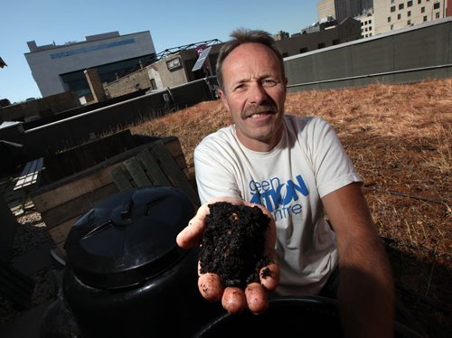 Dave Elmore holds up a handfull of finished compost from the composters atop the MEC Building Downtown. See Jenn Skerrit tale. Aug 22, 2011- (Phil Hossack / Winnipeg Free Press)