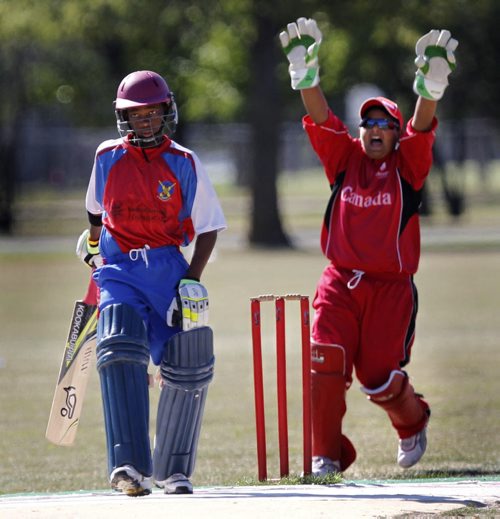 Canadian team Wicket Keeper Sarbjot Singh celebrates play beside Bermuda batsman Delray Rawlins during the last game of the International Cricket Conference Americas Under-15 Northern Division cricket tournament at the Assiniboine Park Cricket Pitch Friday.    Ashley Prest story (WAYNE GLOWACKI/WINNIPEG FREE PRESS) Winnipeg Free Press August 26 2011