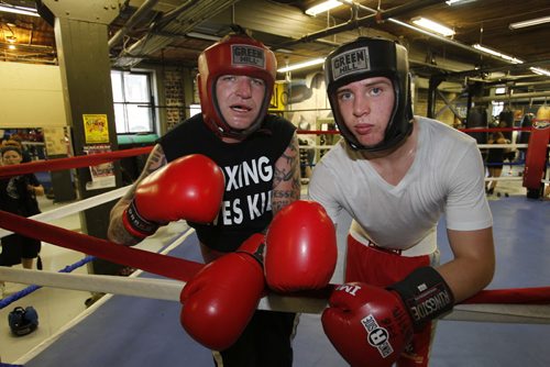 Pan Am boxing club Roland Vandal and 16 year old Julien Carneiro pose for a photo in the club.  August 28, 2011 (BORIS MINKEVICH / WINNIPEG FREE PRESS)