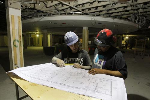 The old McNally Robinson Book Store at Polo Park is being gutted and built into a new store. Some ventilation workers who wanted to be un named check the plans.  August 30, 2011 (BORIS MINKEVICH / WINNIPEG FREE PRESS)