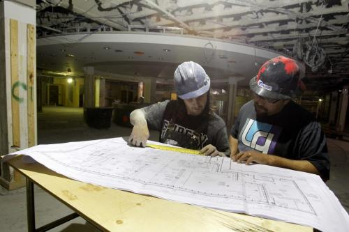 The old McNally Robinson Book Store at Polo Park is being gutted and built into a new store. Some ventilation workers who wanted to be un named check the plans.  August 30, 2011 (BORIS MINKEVICH / WINNIPEG FREE PRESS)