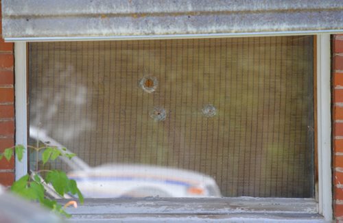 Brandon Sun Bullet holes in the front window of a Simcoe Street home at the scene of an early morning shooting in Carberry, Man., on Monday. (Bruce Bumstead/Brandon Sun)