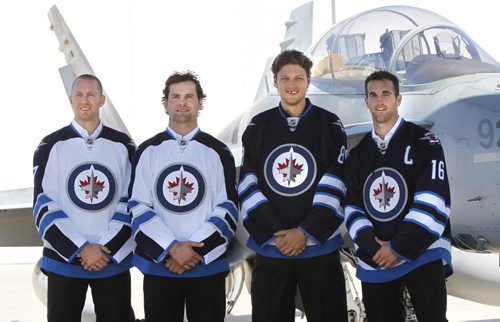 From left, Eric Fehr, Mark Stuart, Nik Antropov and Captain Andrew Ladd at a ceremony at 17 Wing Tuesday, where the Winnipeg Jets unveiled their dark home and white away jerseys.  see Tim Campbell story.  (WAYNE GLOWACKI/WINNIPEG FREE PRESS) Winnipeg Free Press Sept.6   2011
