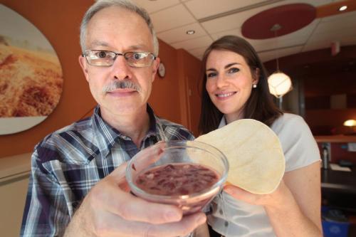 John Longhurst (left) and Emily Cain (right) with the Canadian Foodgrains Bank hold the meal of beans and flatbread which will be eaten at the Famine Lunch on Friday.  See Doug Speirs story 110908 Mike Deal / Winnipeg Free Press